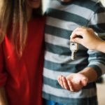 A couple accepting new house keys from their landord.