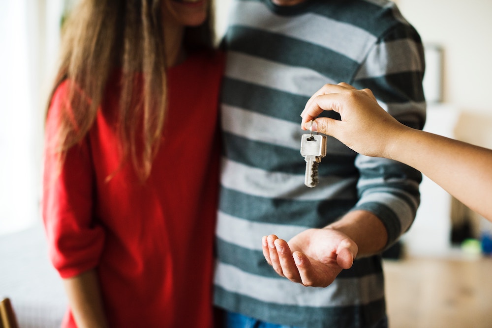 A couple accepting new house keys from their landord.